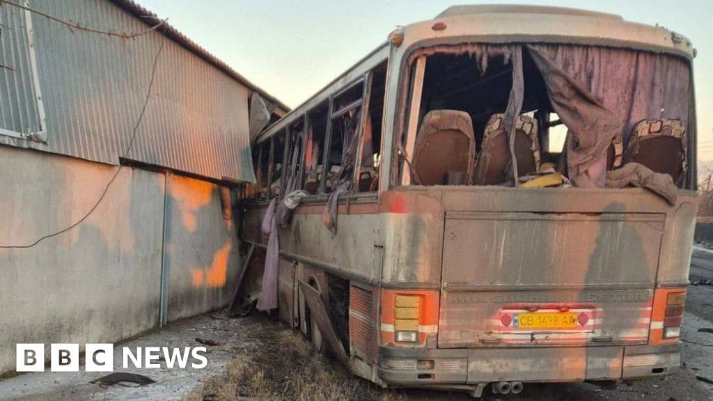 A hyper-realistic, gritty photo-journalistic image of a damaged yellow bus on a gray, dusty road in an industrial area. The windows are shattered, and there is debris and coal dust on the ground. The sky is overcast and gloomy. No gore, but a heavy sense of abandonment and tragedy.