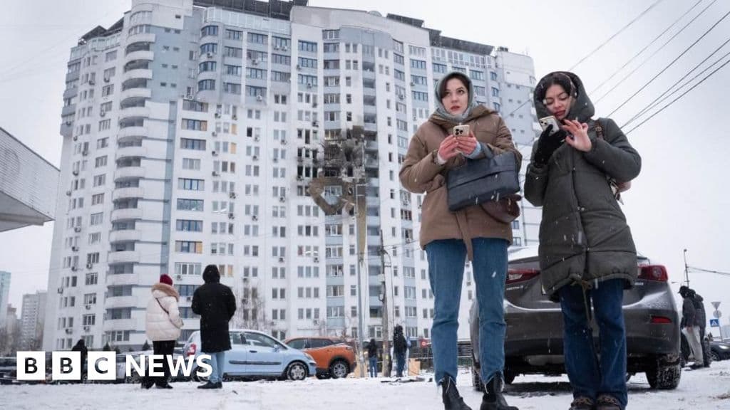 A satirical illustration of a large, ornate red telephone sitting on a block of ice in a snowy landscape, with a dark, stormy sky in the background.