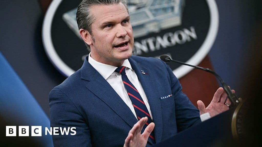 A hyper-realistic, cynical style illustration of US Secretary of Defense Pete Hegseth standing at a sterile, modern press briefing podium. He looks polished, wearing a suit, with a slight smirk or expression of unbothered confidence. Behind him, a blurred American flag. The lighting is harsh and artificial, emphasizing a sense of performative media spectacle.
