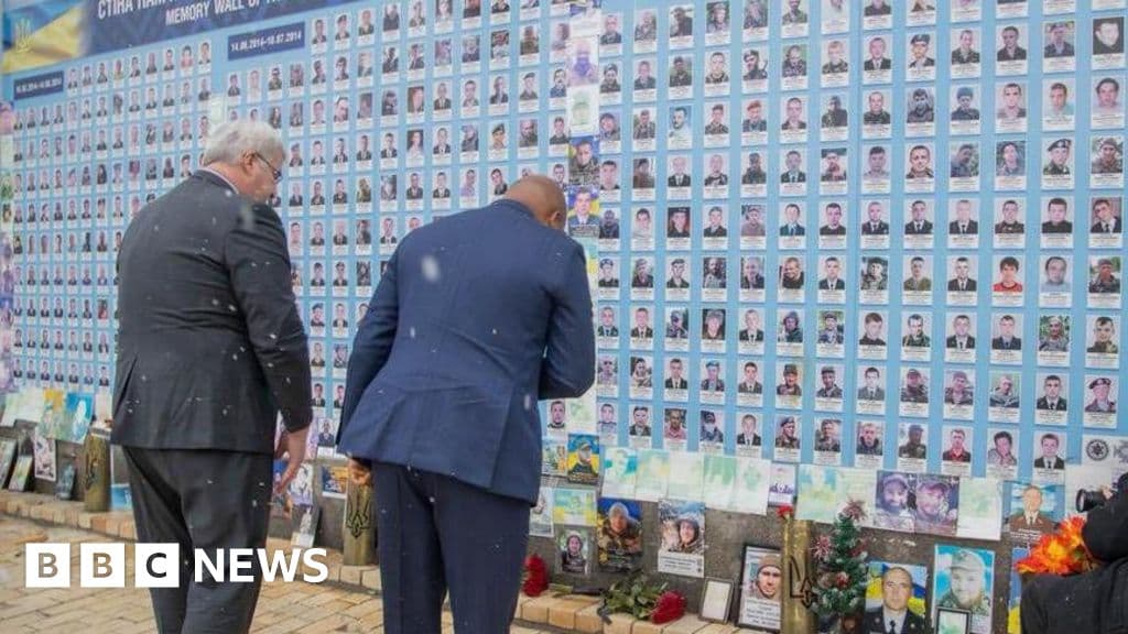 A split composition illustration. On the left side, a warm, dusty street scene in Ghana with bright sun and shadows. On the right side, a bleak, freezing winter battlefield in Eastern Europe with grey snow, barbed wire, and a discarded military boot. The contrast between the two worlds should be sharp and gritty.