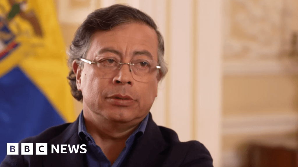 A cynical, high-contrast caricature in the style of a dark political cartoon. A bloated, orange-skinned man with golden hair sits on a throne made of oil barrels and missiles, pointing a tiny finger toward a map of South America. Opposite him, a man in a rumpled suit with a presidential sash stands on a pile of revolutionary pamphlets, screaming into a megaphone labeled 'BBC' while holding a sign that says 'I AM A VICTIM.' The background is a smoggy, grey wasteland of abandoned drug labs and empty diplomatic buildings.