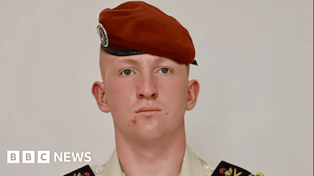 A gritty, slightly blurred photo of a pair of military combat boots sitting empty on a concrete floor in a dimly lit barracks, capturing a mood of cold, harsh silence and absence.
