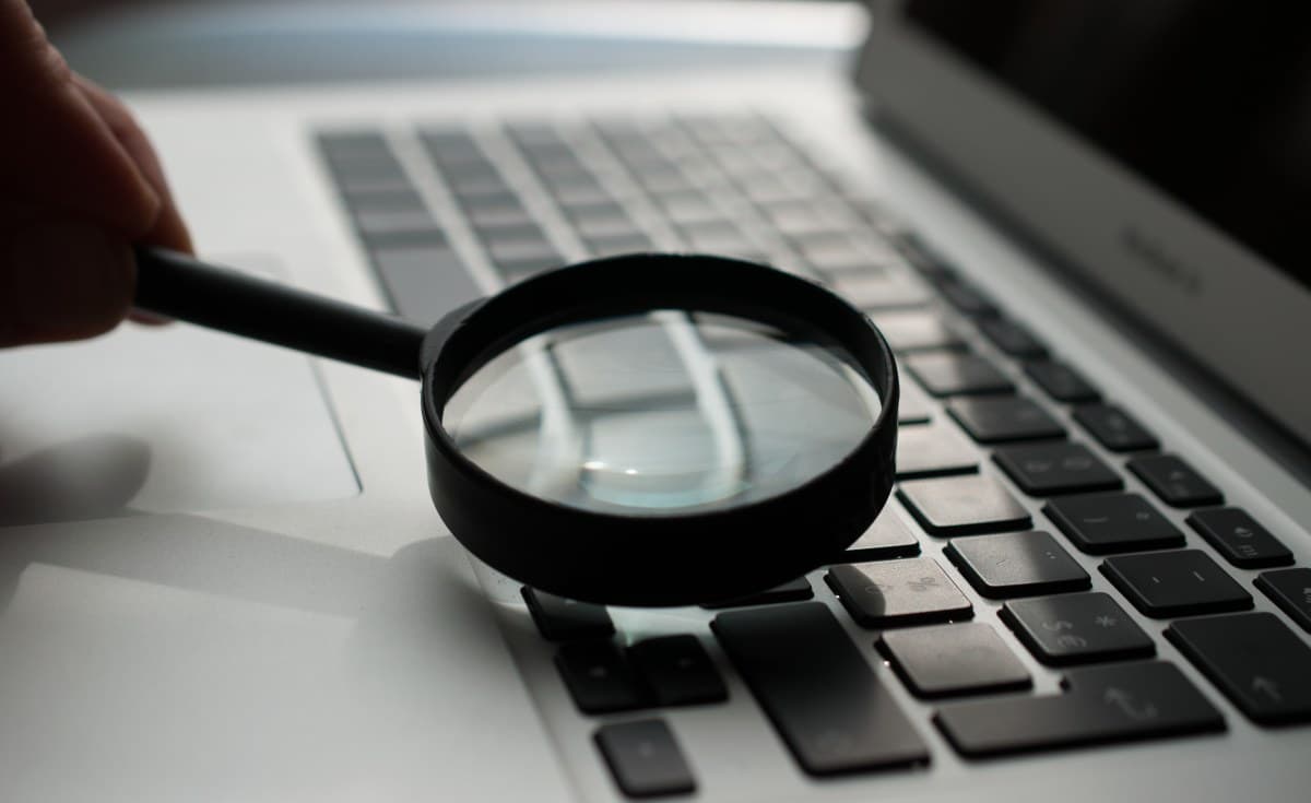 A hyper-realistic, dark satirical digital painting of a glitching, robotic African politician behind a podium, his face half-human and half-pixelated screen, speaking into a cluster of microphones shaped like snakes, in a dimly lit, decaying government hall.