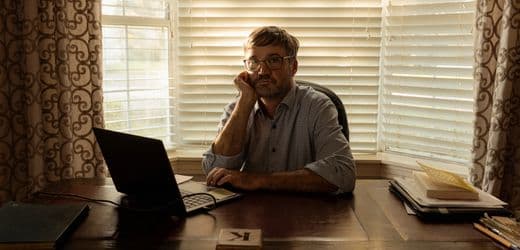 A gritty, cinematic wide shot of a rusted, sprawling migrant detention center rising out of a Louisiana swamp. A lone, tired lawyer in a rumpled suit stands in the foreground, clutching a stack of legal papers, looking up at a massive, faceless concrete wall topped with razor wire. The sky is a sickly, jaundiced yellow, and the water is dark and stagnant.