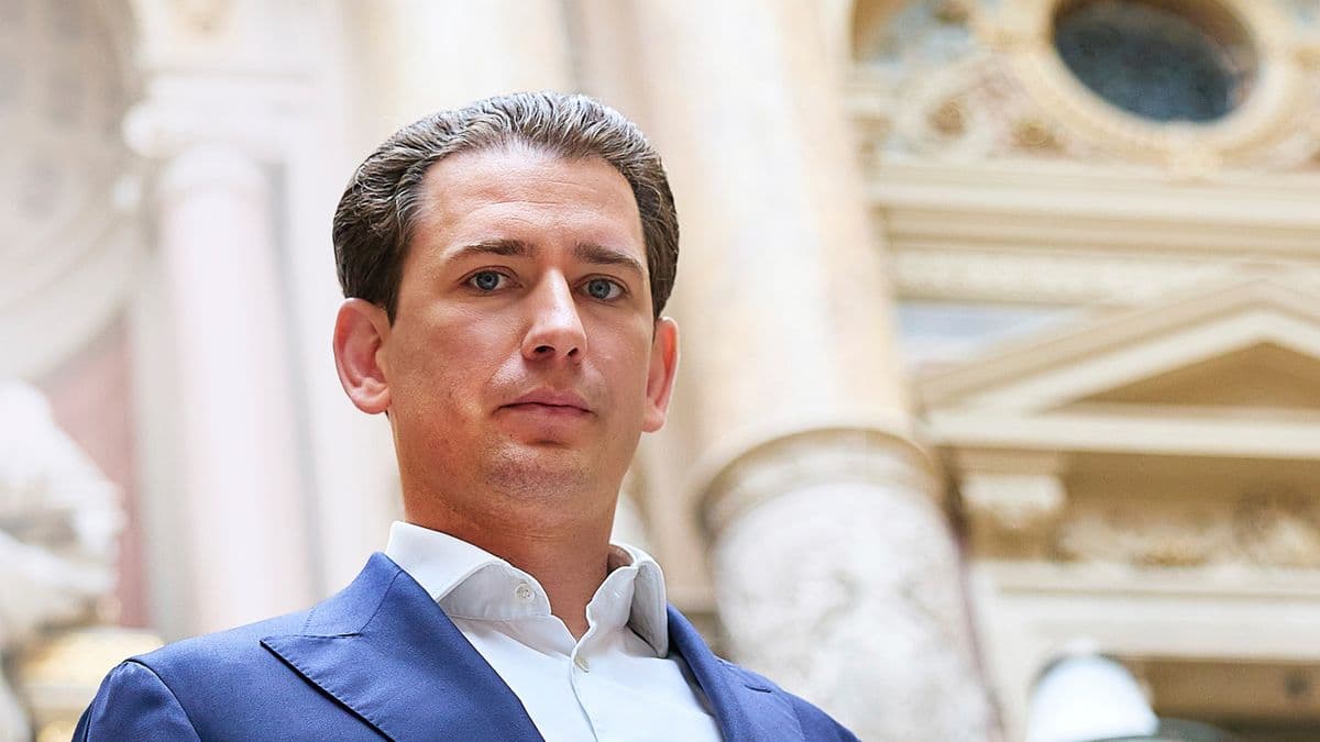 A hyper-realistic, satirical portrait of Sebastian Kurz wearing a high-tech Patagonia vest over a slim-fit suit, standing in a sterile, futuristic boardroom that overlooks a blurred skyline of Vienna and Silicon Valley. His face is perfectly symmetrical and slightly robotic. In the background, a translucent digital display shows stock tickers and political maps merging into one. The lighting is cold, blue, and corporate.