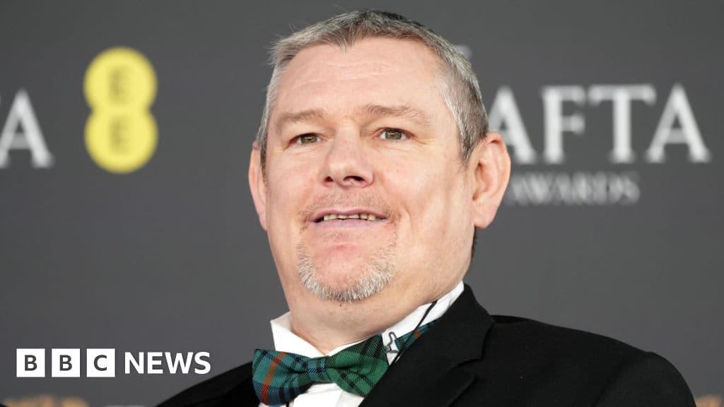 A dimly lit, cluttered writers' room with crumpled paper on the floor and a blank whiteboard, conveying a sense of creative bankruptcy and exhaustion, realistic style.