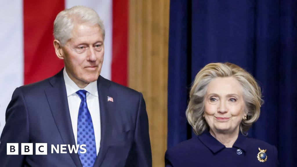 A highly realistic, moody editorial illustration of Bill and Hillary Clinton sitting side-by-side at a long wooden witness table, looking bored and defiant. In front of them are microphones and glasses of water. The background is a blurred Congressional hearing room with dark wood paneling and the American flag. The lighting is dramatic and slightly shadowy, emphasizing a cynical atmosphere.