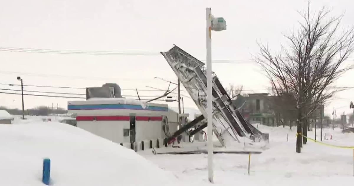 A satirical illustration of a chaotic American street scene during a winter storm. In the foreground, a panicked person is pushing a shopping cart overflowing with bread and milk through deep snow. In the background, a politician stands on a podium made of ice, speaking into a microphone while power lines spark and sag behind them. The scene is cold, blue, and dimly lit, highlighting the absurdity of the panic.