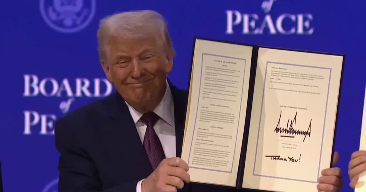 A satirical, hyper-realistic image of a giant, golden 'FOR SALE' real estate sign stuck deep into a pristine, snowy iceberg in Greenland. In the background, a modern aircraft carrier floats ominously in the icy water. In the foreground, a confused polar bear looks at the sign. The sky is dramatic and moody, capturing a sense of cold absurdity.