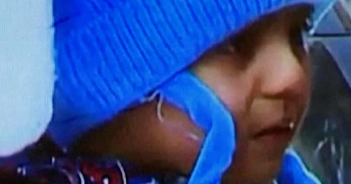 A highly satirical, gloomy illustration in the style of political caricature. A massive, towering wall of grey filing cabinets and stone bureaucracy looms over a tiny, lonely teddy bear left on the floor. In the shadows, faceless figures in uniforms holding clipboards look down sternly. The lighting is cold and clinical, emphasizing the size difference between the massive state machinery and the small, innocent object.