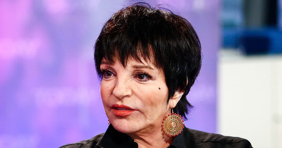 A hyper-realistic, slightly grotesque portrait of a digital mannequin resembling Liza Minnelli, constructed from glowing fiber-optic cables and circuit boards, singing into a microphone made of silicon wafers, in a cold, empty, futuristic recording studio with a cynical, noir atmosphere, vibrant but artificial stage lighting.