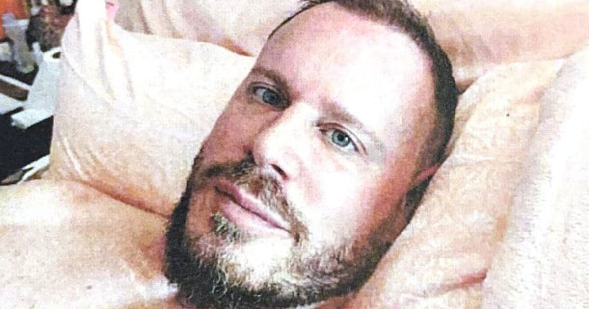 A satirical editorial illustration of a man standing on an Olympic podium, but instead of a gold medal, he is holding a large suitcase leaking white powder. The background is a mix of a snowy mountain and a dark city alley, in a minimalist, high-contrast style with deep blues and sharp shadows.