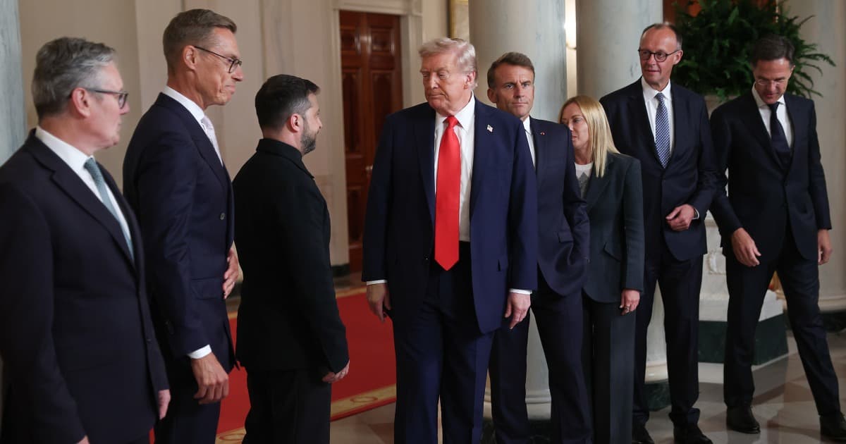 A sophisticated, cynical oil painting of a weathered European diplomat in a sharp charcoal suit, sitting in a dimly lit, ornate Parisian office. He is staring with weary disdain at a small, glowing miniature nuclear missile sitting on a silver tray next to a glass of dry sherry. In the background, a large window reveals an overcast sky where a tattered American flag is blowing away in the wind. The style is moody and intellectual, with a focus on rich textures and a sense of impending, quiet doom.