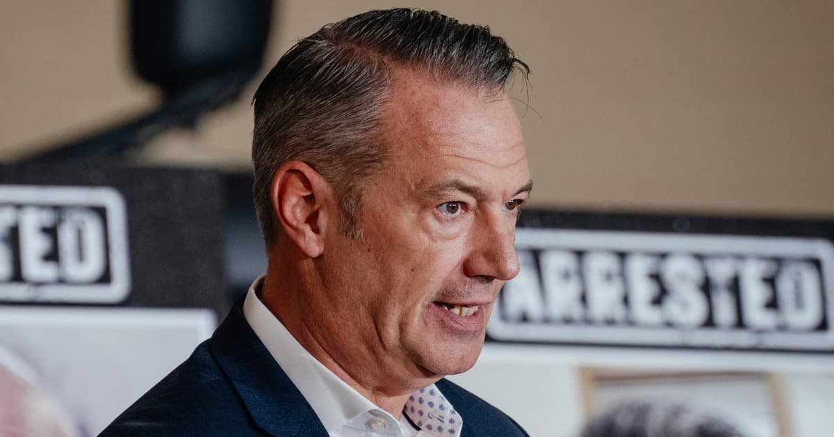A hyper-realistic, gritty courtroom sketch style image. In the foreground, a nervous, sweating government bureaucrat in a suit is loosening his tie, looking terrified. In the background, a stern judge in black robes points a gavel aggressively like a weapon. The atmosphere is tense and chaotic.