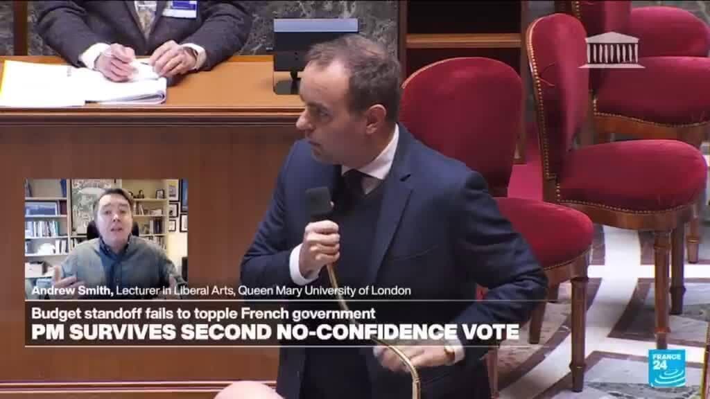 A satirical illustration of a tired French Prime Minister standing on a tightrope over a canyon. On one side of the canyon, people in red shirts are yelling 'Right Wing!' and on the other side, people in blue shirts are yelling 'Socialist!' The Prime Minister is holding a large golden button labeled '49.3' while the tightrope starts to fray. High-contrast, editorial cartoon style.