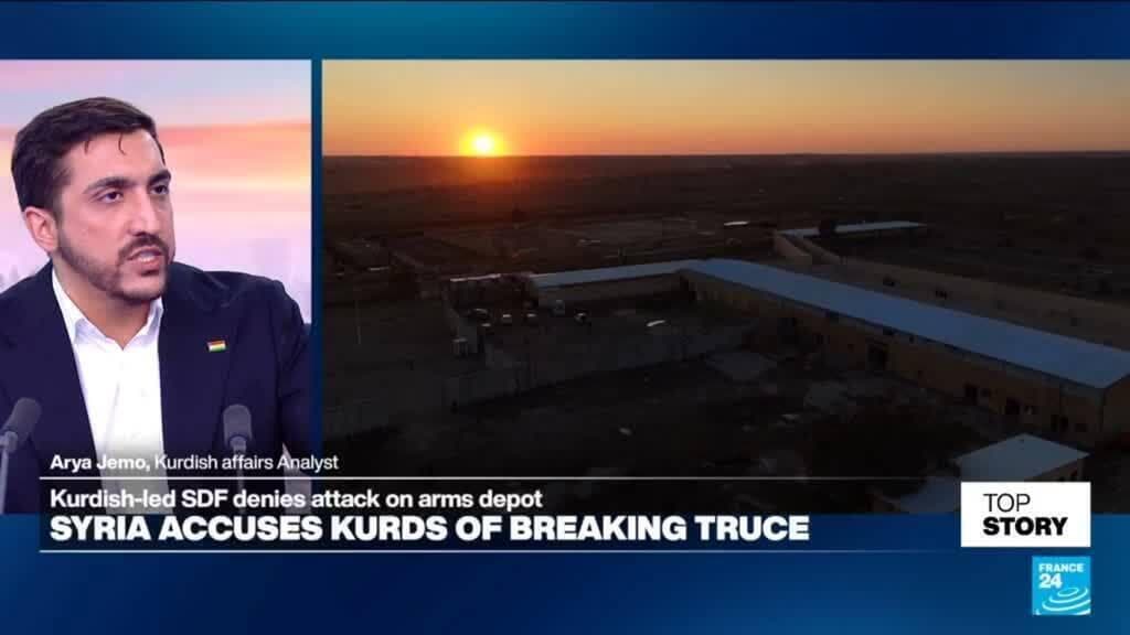 A high-end television studio in Paris with a sleek glass desk and professional lighting, but the floor is covered in thick gray rubble and spent shell casings. On the monitors behind the host, a serene image of a blue sky is visibly glitching and pixelating. Cinematic lighting, sharp focus, satirical contrast between luxury and destruction.