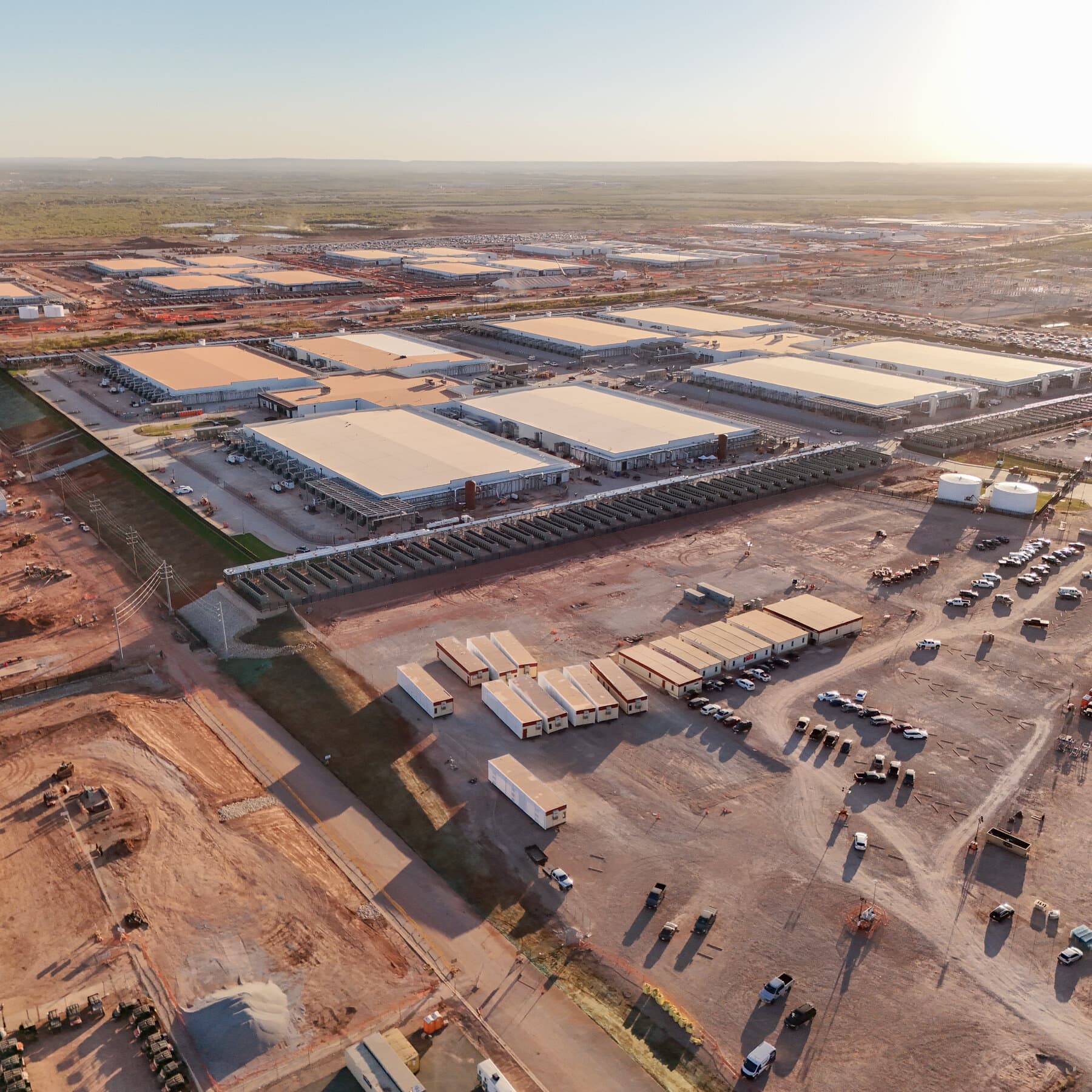 A gritty, monochromatic political cartoon style illustration. In the foreground, a fat politician in a suit is screaming at a tech executive in a hoodie. They are standing waist-deep in rising water. Between them is a massive computer server rack that is visibly overheating and catching fire. In the background, a chaotic web of power lines is snapping and sparking. The atmosphere is gloomy and cynical.