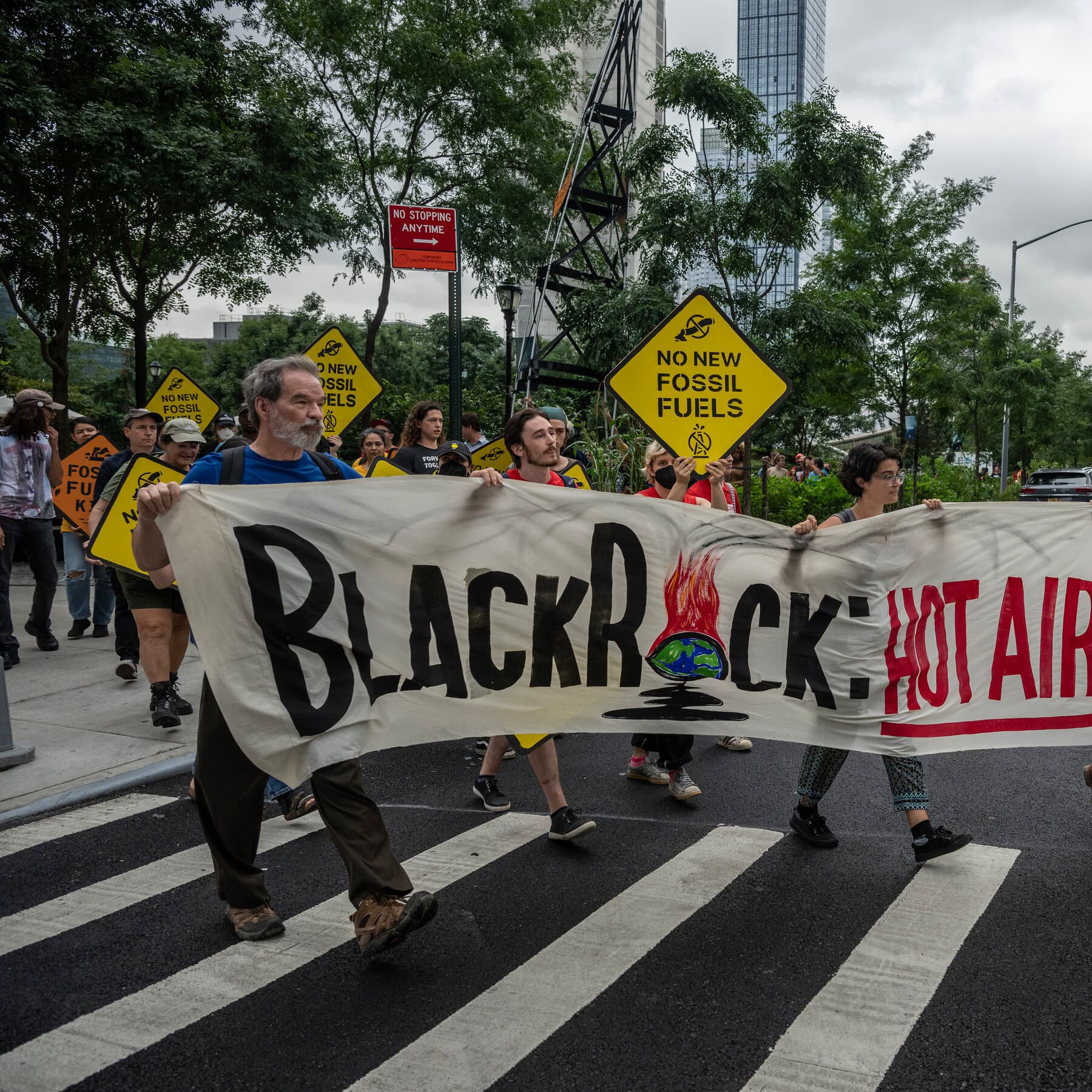 A photorealistic satirical image of a group of wealthy Wall Street bankers in expensive suits laughing hysterically and clinking champagne glasses while standing waist-deep in ocean water on the floor of the New York Stock Exchange.