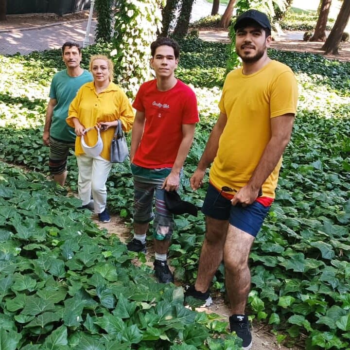 A gritty, high-contrast black and white illustration of a single human hand reaching up from a pile of rubble and gray concrete, grasping at empty air. Dark, oppressive shadows loom over the scene.