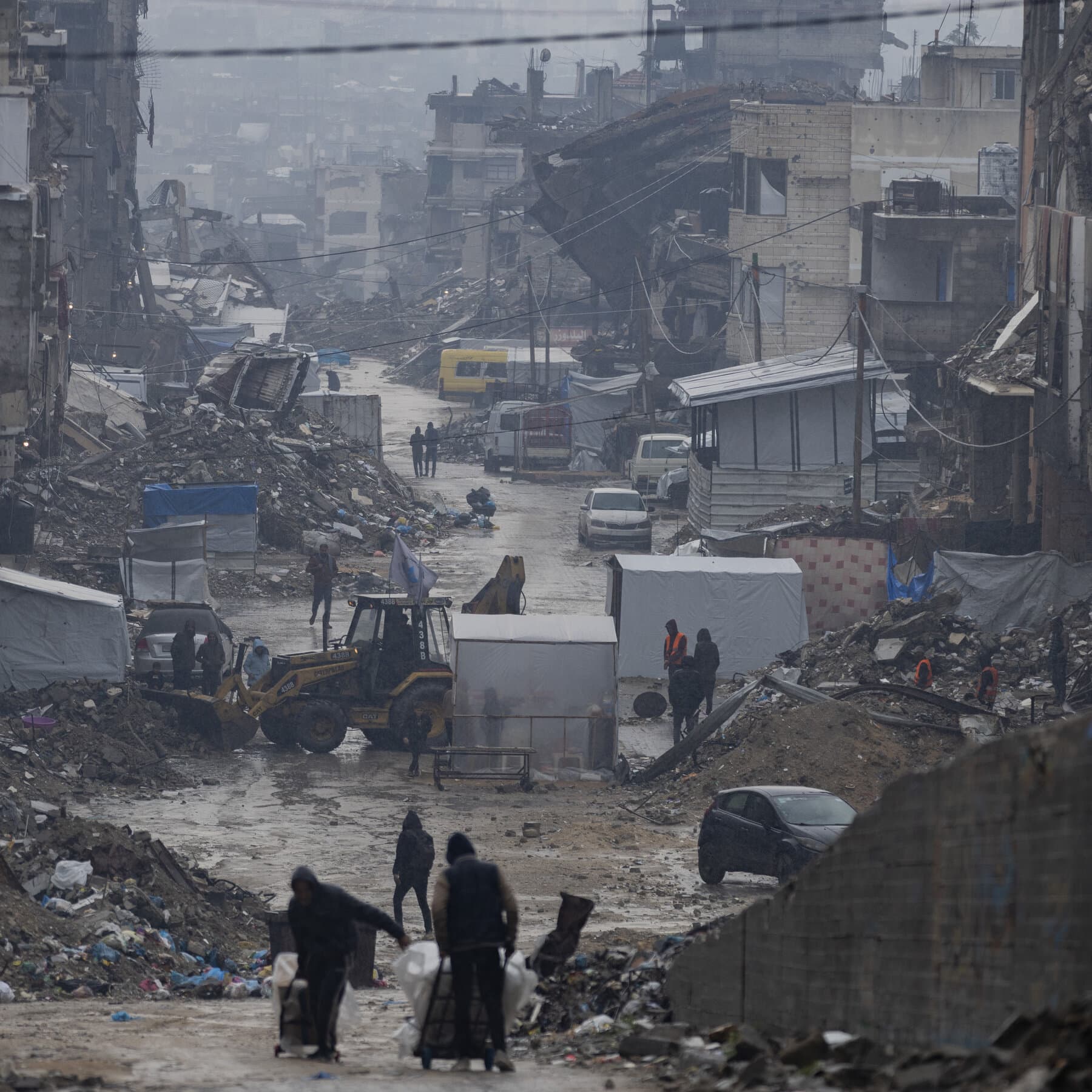 A satirical news photo of Donald Trump at a podium in Mar-a-Lago unveiling a gold-plated logo that looks exactly like the United Nations emblem but with added lens flare and dollar signs. Behind him is a banner reading 'United Nations Pro Max: The Snyder Cut.' He is flanked by a cardboard cutout of himself and a confused-looking foreign diplomat holding a giant novelty check.