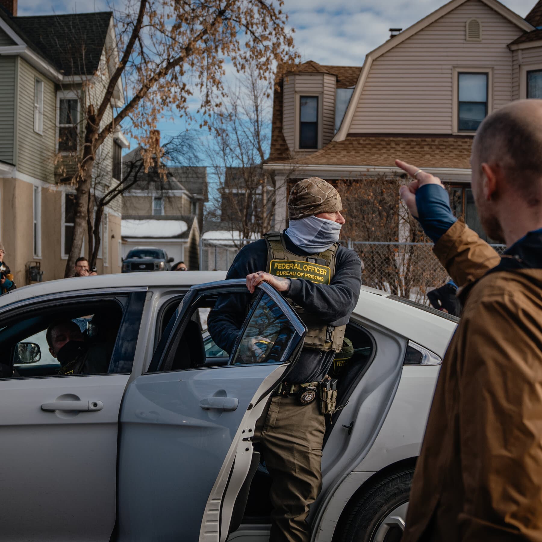 A wide-angle, cinematic shot of a courtroom in a blizzard. On one side, federal agents in dark tactical gear stand like statues. On the other, local politicians in expensive suits hold up fragile pieces of paper. The judge in the center looks exhausted, head in hands. The lighting is cold, blue, and cynical, emphasizing the futility of the scene. High detail, satirical style. No text.