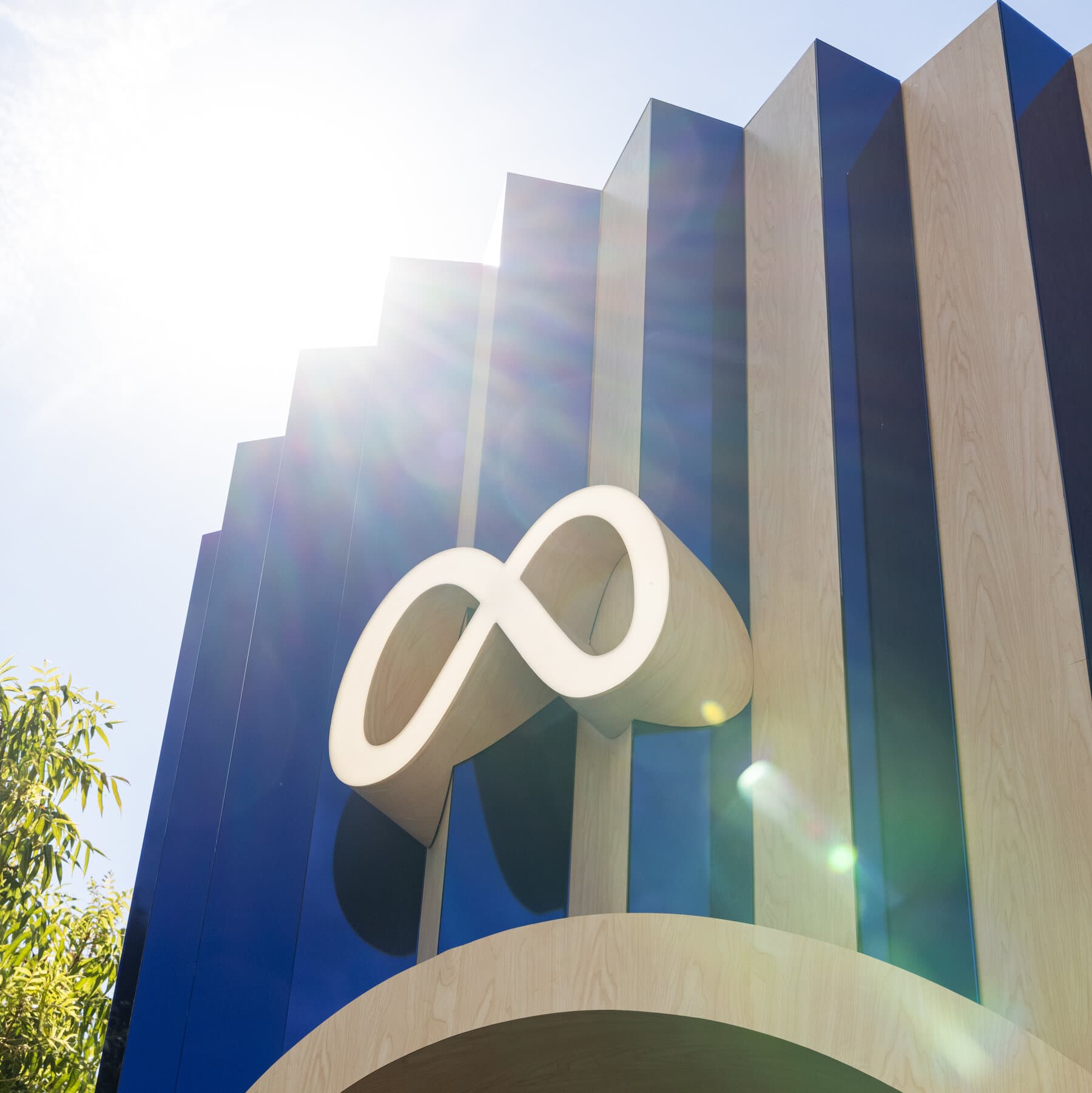 A cynical, hyper-realistic digital painting of a weary bureaucrat in a tattered grey suit, attempting to push a massive, glowing blue 'M' logo up a steep mountain of discarded, cracked smartphones. The sky is a toxic shade of corporate blue, filled with floating 'Like' icons and digital static. The bureaucrat's shadow is being stretched into a barcode by the eerie light of the mountain. Dark, satirical, and sharp detail.
