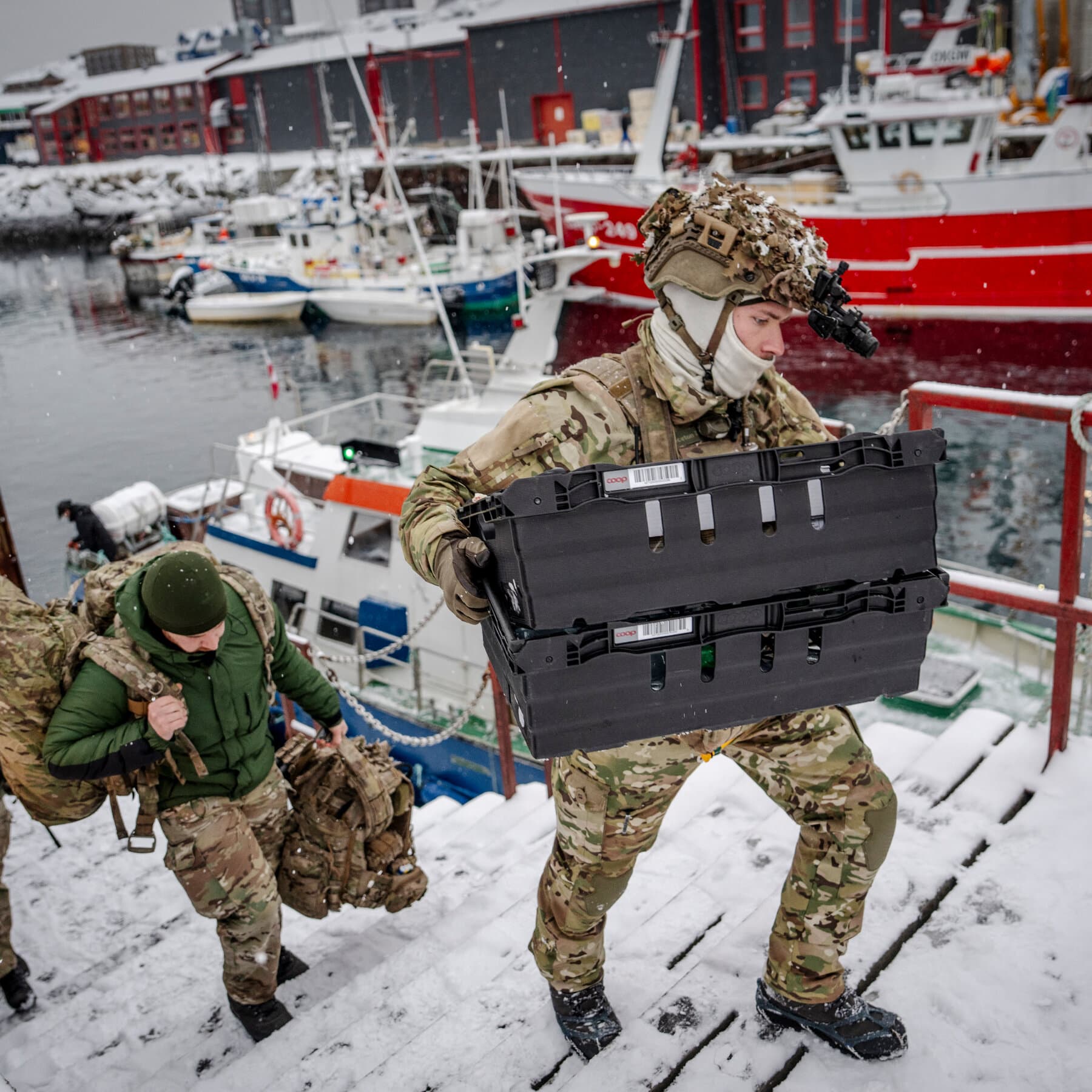 A doctored weather map showing a red sharpie hurricane path heading toward Greenland, with Donald Trump yelling at a single confused Danish soldier holding a pair of skis.