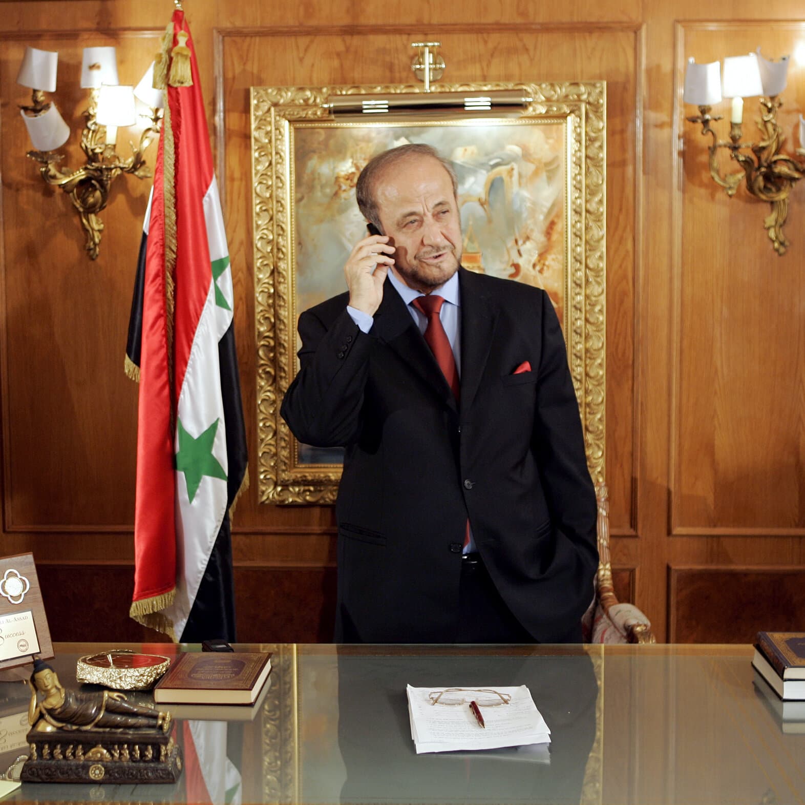 A hyper-realistic, cynical conceptual image depicting a luxurious Parisian drawing room slowly dissolving into gray concrete rubble and dust. In the center, an ornate, velvet armchair sits empty, surrounded by shattered classical statues and faint, ghostly outlines of an ancient city skyline in the background. The lighting is cold and twilight-blue, emphasizing a sense of hollow abandonment and historical decay.