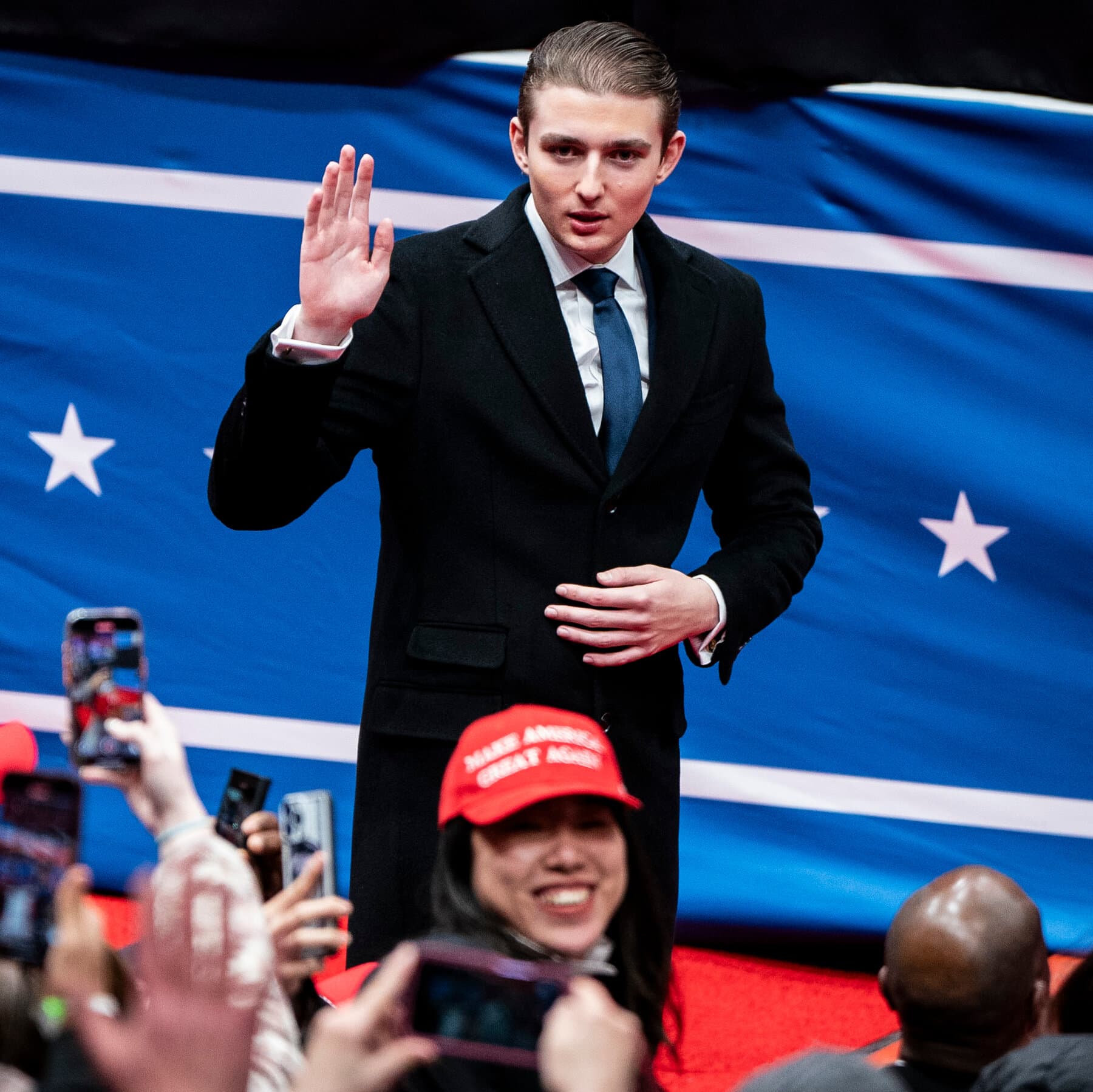 A sophisticated oil painting in the style of Edward Hopper. A tall, solitary teenage figure stands in a dimly lit, luxurious room in Florida, looking at a laptop screen. The screen shows a grainy, dark video call of a London street at night. The reflection in the window shows both palm trees and the rainy London skyline, merging the two worlds. The atmosphere is cynical, cold, and detached.