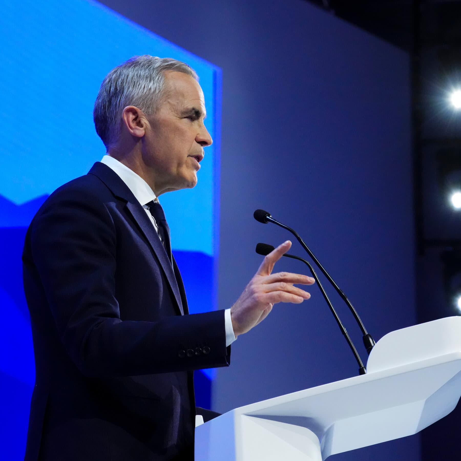 A satirical political cartoon style illustration showing a fancy cocktail party in the snowy mountains. A man in a sharp business suit is standing on a soapbox labeled 'The Expert,' lecturing a snowman wearing a long red tie. A crowd of wealthy elites in fur coats and tuxedos are clapping enthusiastically for the man in the suit, while a massive avalanche labeled 'REALITY' looms directly behind them, about to crash down. The style should be cynical and detailed.