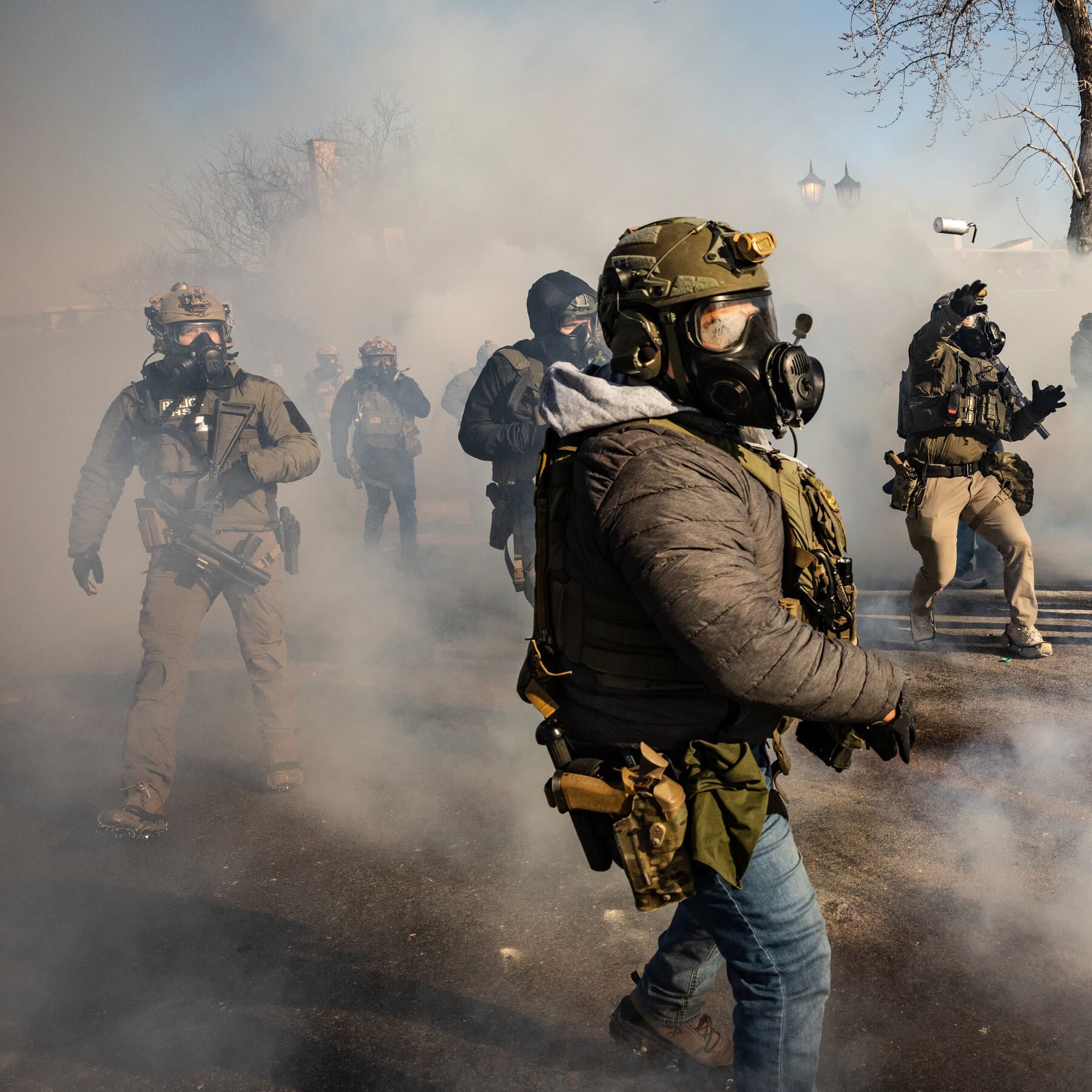 A gritty, cynical editorial illustration showing a group of American ICE agents wearing tactical gear and sunglasses standing awkwardly on a snowy Italian ski slope, holding coffees and looking out of place, while confused Italian locals gesture angrily in the background. High contrast, muted colors.