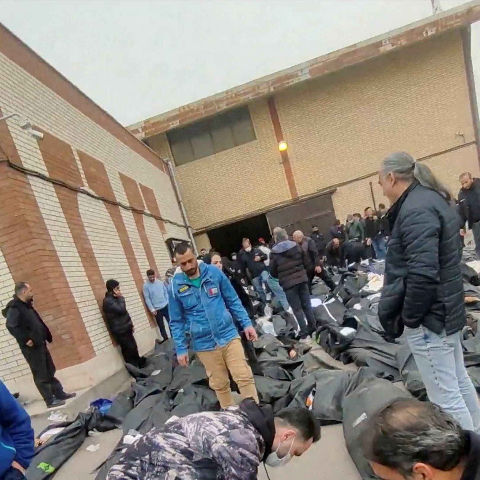 A highly cynical, abstract editorial illustration depicting a group of faceless bureaucrats in suits sitting around a large, polished table in a lavish European meeting room. They are solemnly stamping a piece of paper with red ink while a fire rages visibly through the window behind them. The style should be gritty and satirical, highlighting the disconnect between the calm, useless meeting and the chaos outside.