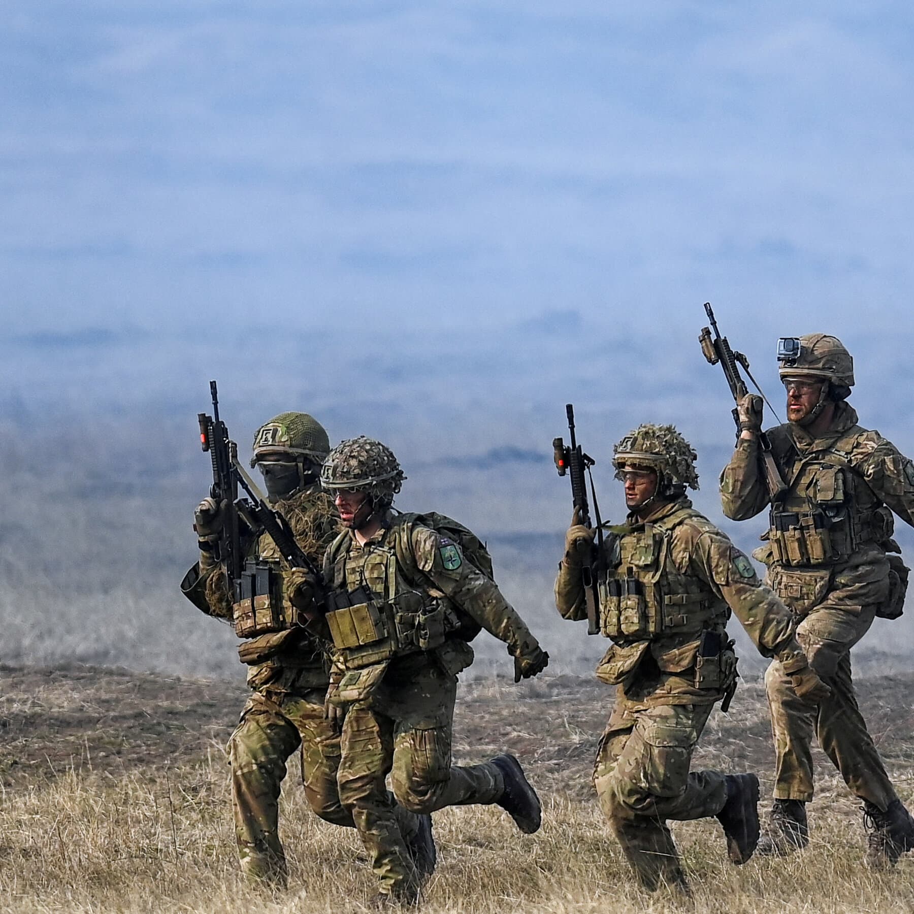 A moody, high-contrast editorial illustration showing a round conference table with many European flags, but one large, conspicuous empty chair with a US flag draped over it. The room is dimly lit, with worried-looking bureaucrats in suits whispering to each other. The atmosphere is cold, grey, and cynical.