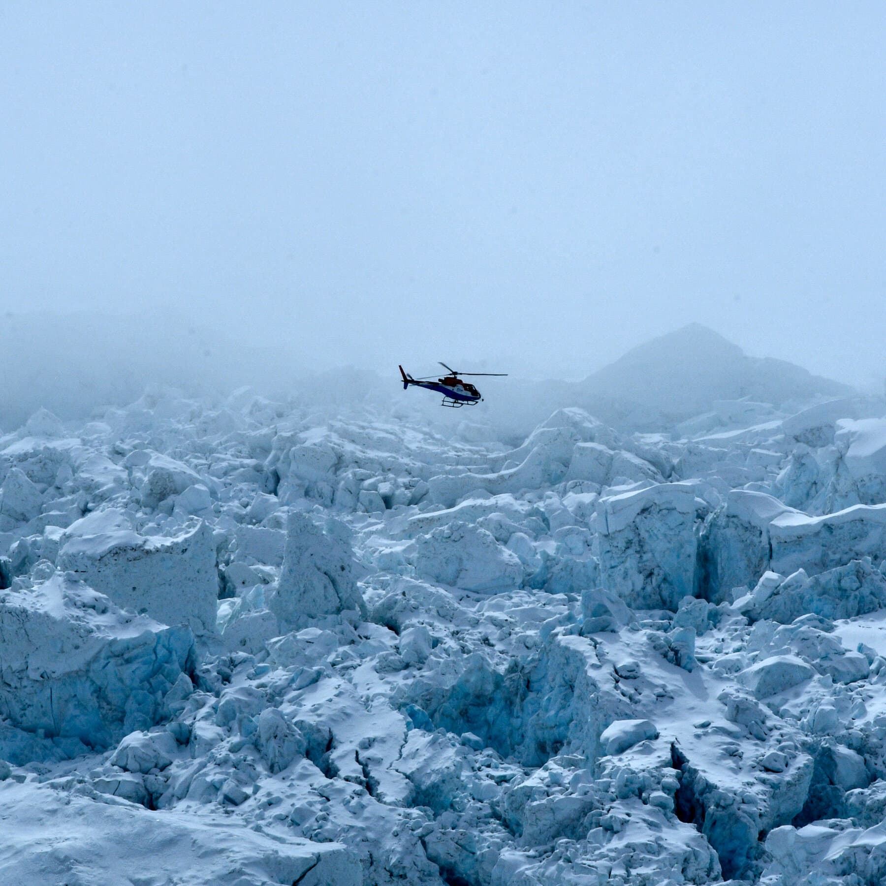A satirical illustration of Mount Everest where the peak is replaced by a giant overflowing cash register, with helicopters flying away carrying bags of money instead of people, in a gritty cynical art style.