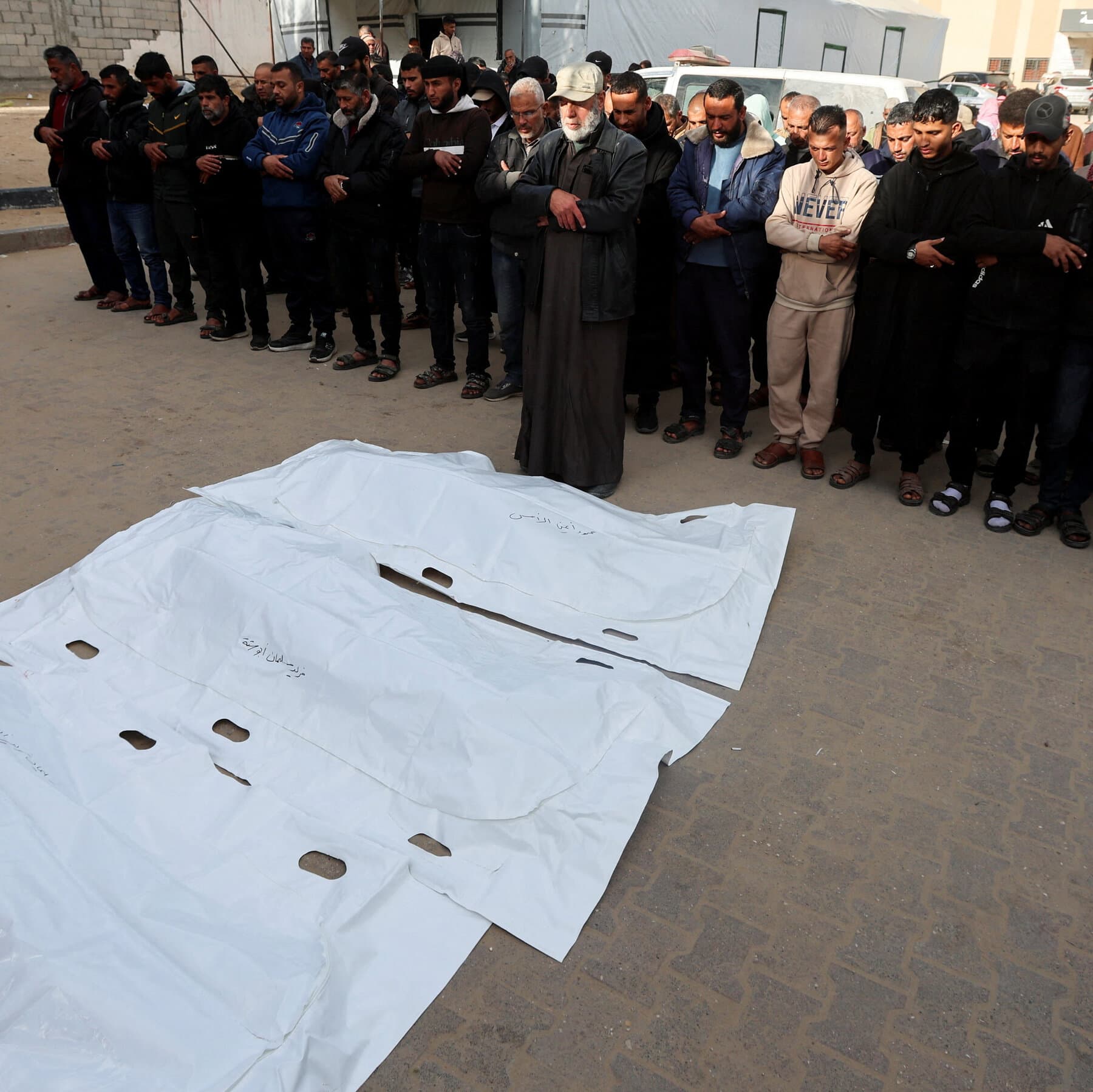 A gritty, black and white photo of a single child's shoe lying alone in a pile of grey concrete rubble and dust, sharp focus, high contrast, depressing atmosphere.