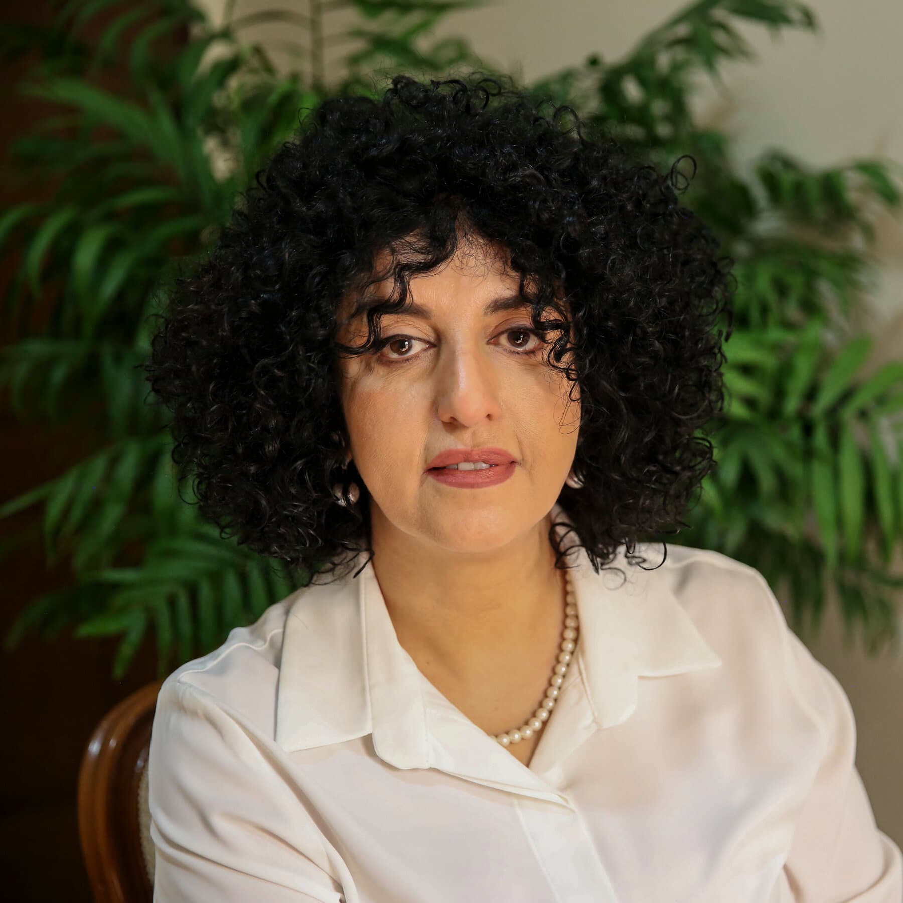 A gritty, high-contrast illustration of a single, empty metal prison plate sitting on a cold, cracked concrete floor. Long, dark shadows of prison bars stretch across the plate. The colors are desaturated greys and blues, emphasizing isolation and hunger. No people, just the empty plate.