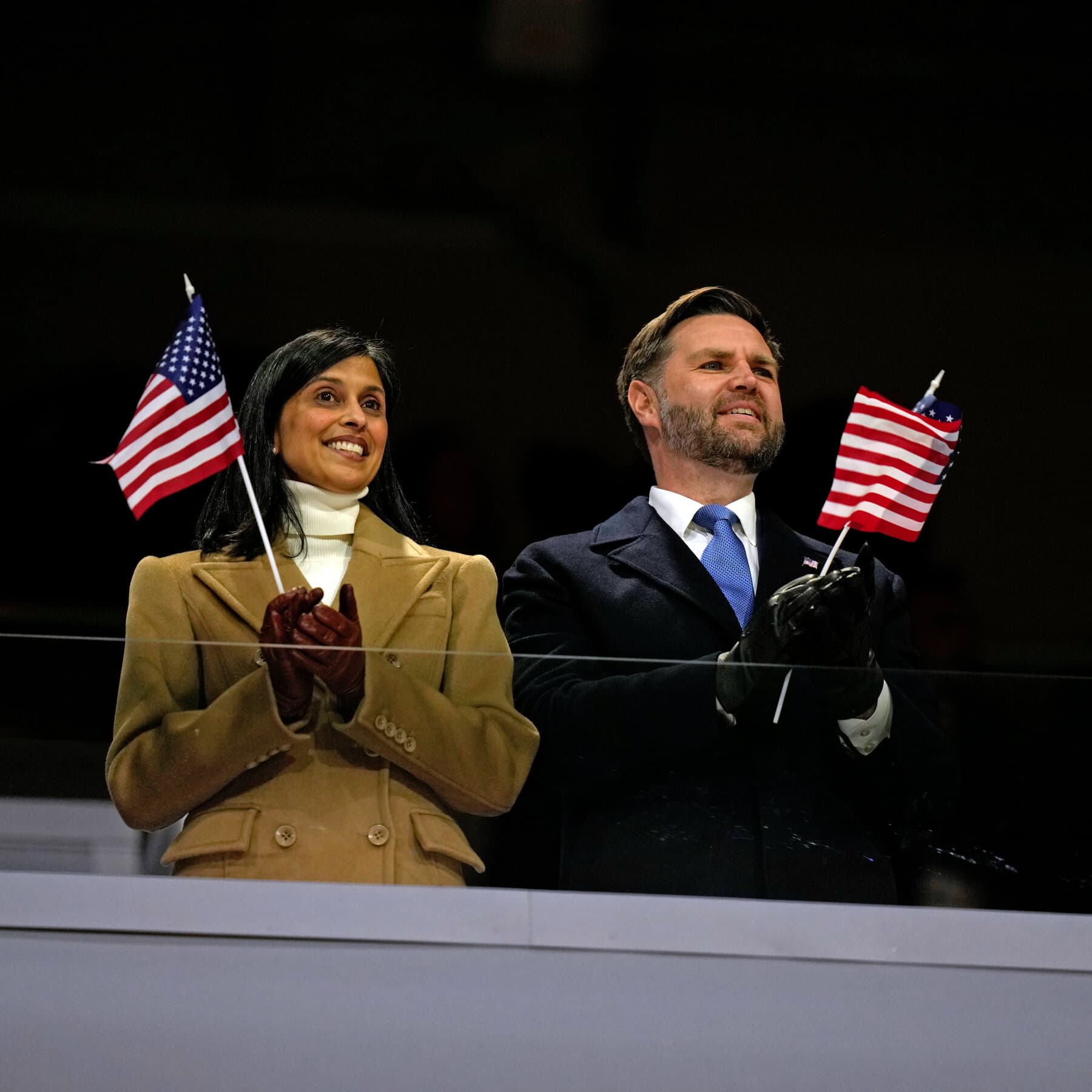 A high-contrast, moody illustration of a large stadium crowd in winter coats, their faces blurred but clearly angry, jeering towards a small, isolated figure of a politician in a suit standing under a harsh spotlight. In the background, shadowy figures resembling security guards stand watch. The color palette should be cold blues, greys, and stark white snow.