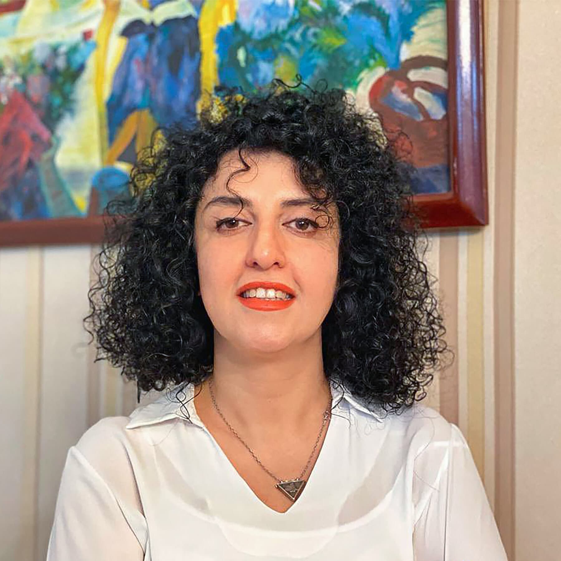 A conceptual editorial illustration in a noir style. On the left side, a glowing golden Nobel Peace Prize medal rests on a velvet cushion. On the right side, the image transitions into a dark, gritty prison cell with heavy iron bars and a cold concrete floor. The lighting is dramatic, highlighting the contrast between the shiny award and the grim reality of the cell. No text.