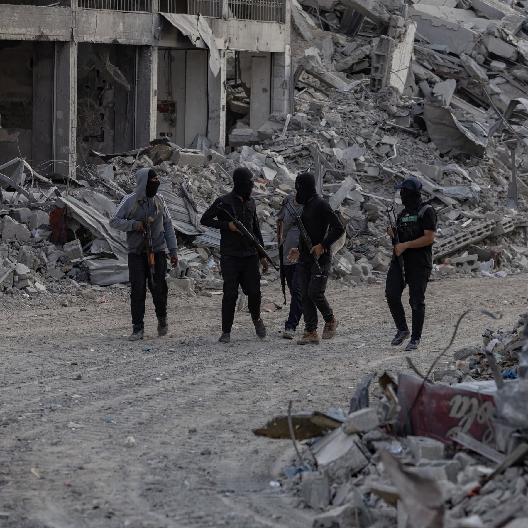 A high contrast, gritty black and white photo of a crumpled piece of paper lying in the dirt. The paper has the word PEACE faintly written on it, covered in dust and boot prints. The background is out of focus rubble.