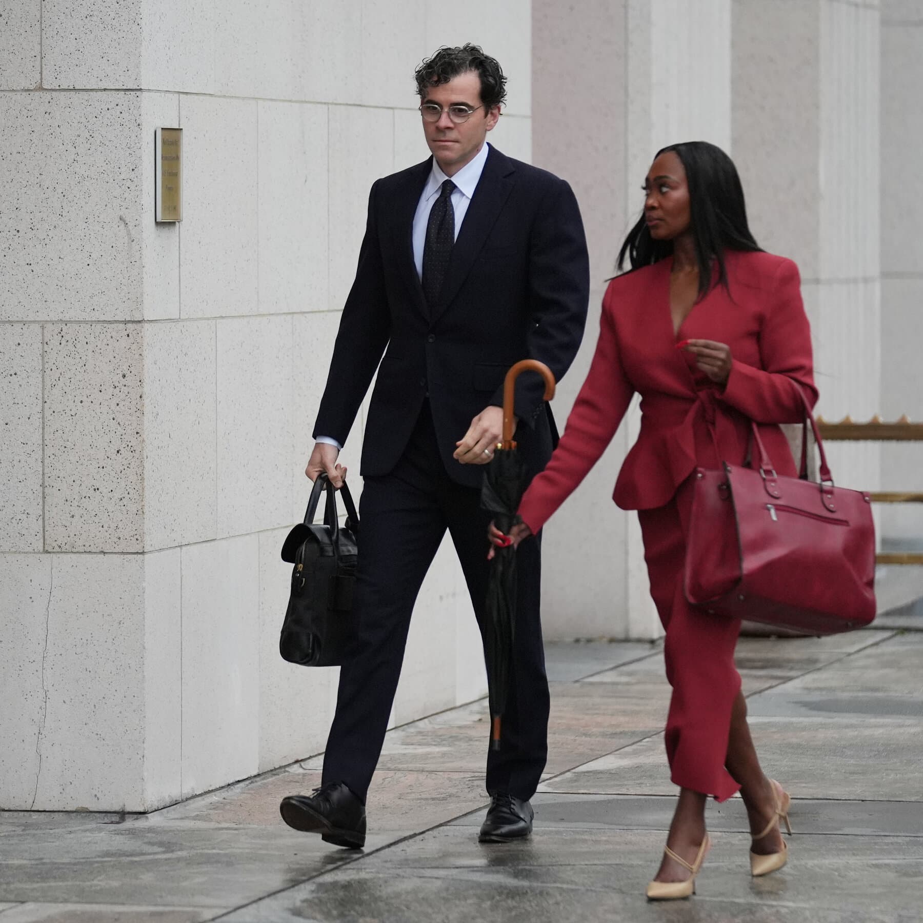 A dark, gritty courtroom sketch in high contrast. A man in a sharp suit stands at a witness stand, looking smug. Behind him, a giant, glowing smartphone looms like a black monolith, casting a cold blue light. The audience is faceless, all looking down at their hands. The mood is cynical and cold.