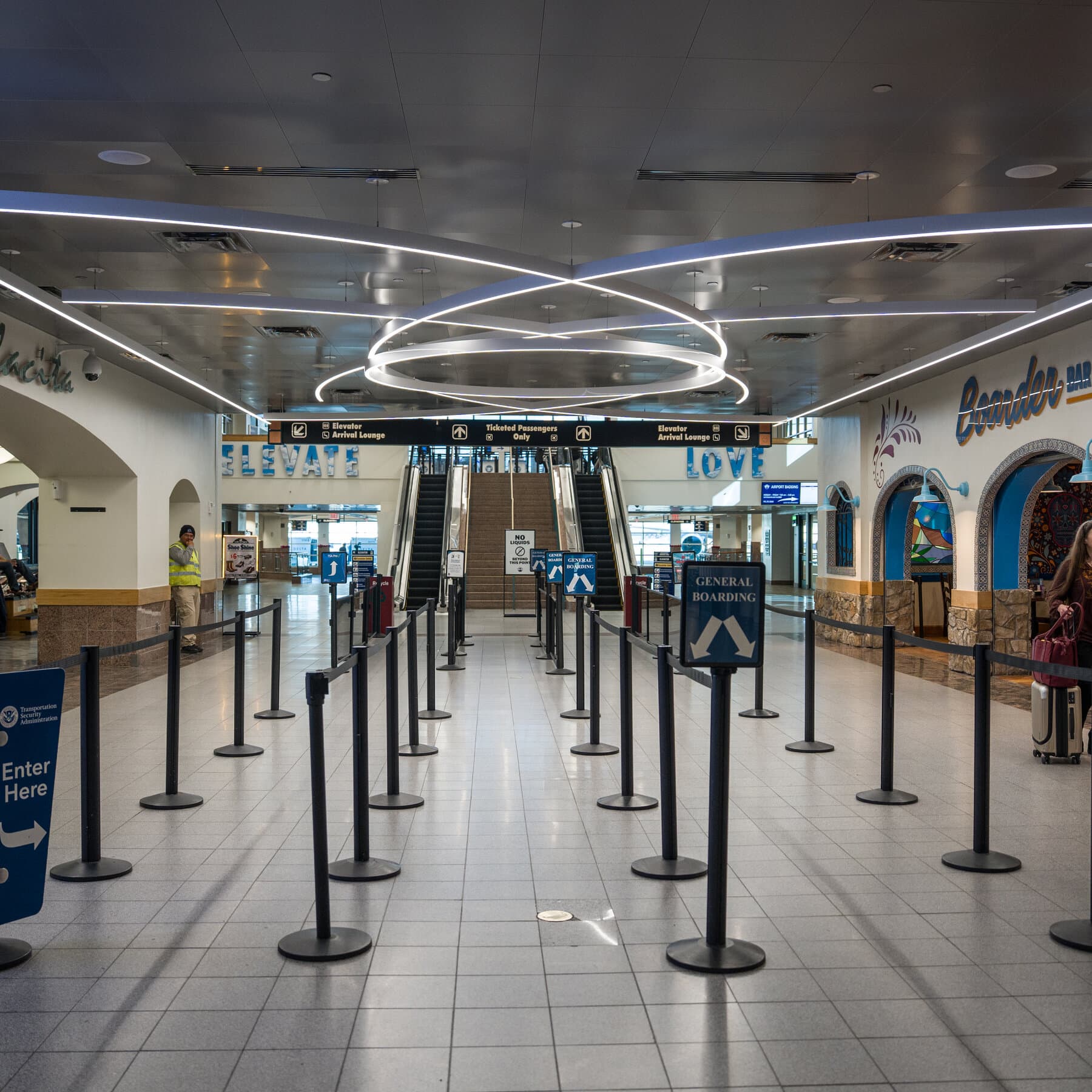 A gritty, cynical comic book style illustration of a chaotic airport terminal. Passengers look exhausted and angry, sleeping on floors. A flight information board in the background shows 'DELAYED' and 'CANCELLED' in bright red letters. In the foreground, a man in a suit is yelling into a phone while a confused pilot looks at a map upside down. The colors should be muted grays and harsh reds.