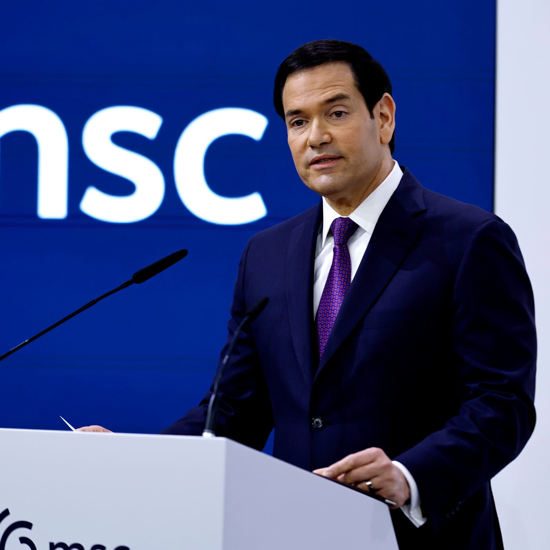 A surreal, monochromatic illustration of a generic politician in a suit speaking at a podium made of melting clocks, with an audience of faceless figures clapping in a grand, shadowy European hall. High contrast, noir style.