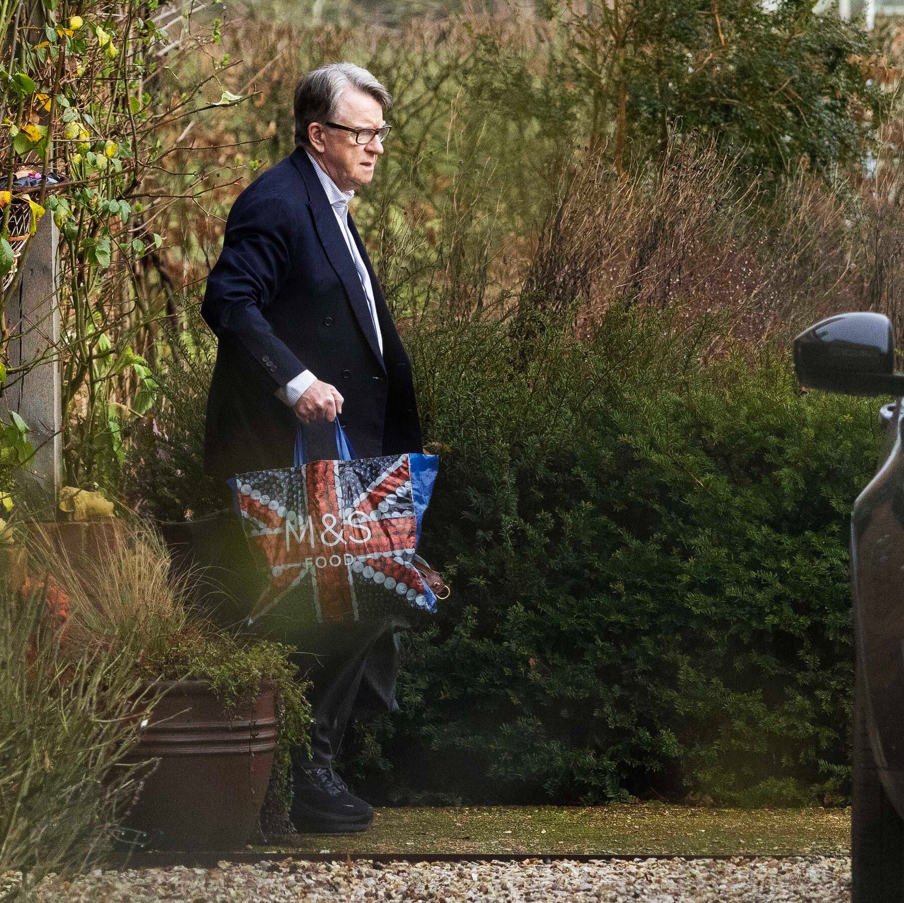 A conceptual editorial illustration in a dark, noir style. A silhouette of a man in a sharp suit stands amidst the crumbling stone pillars of the British Parliament. He is tangled in marionette strings that are snapping and fraying. The lighting is high-contrast and moody, emphasizing shadows and decay. No text.