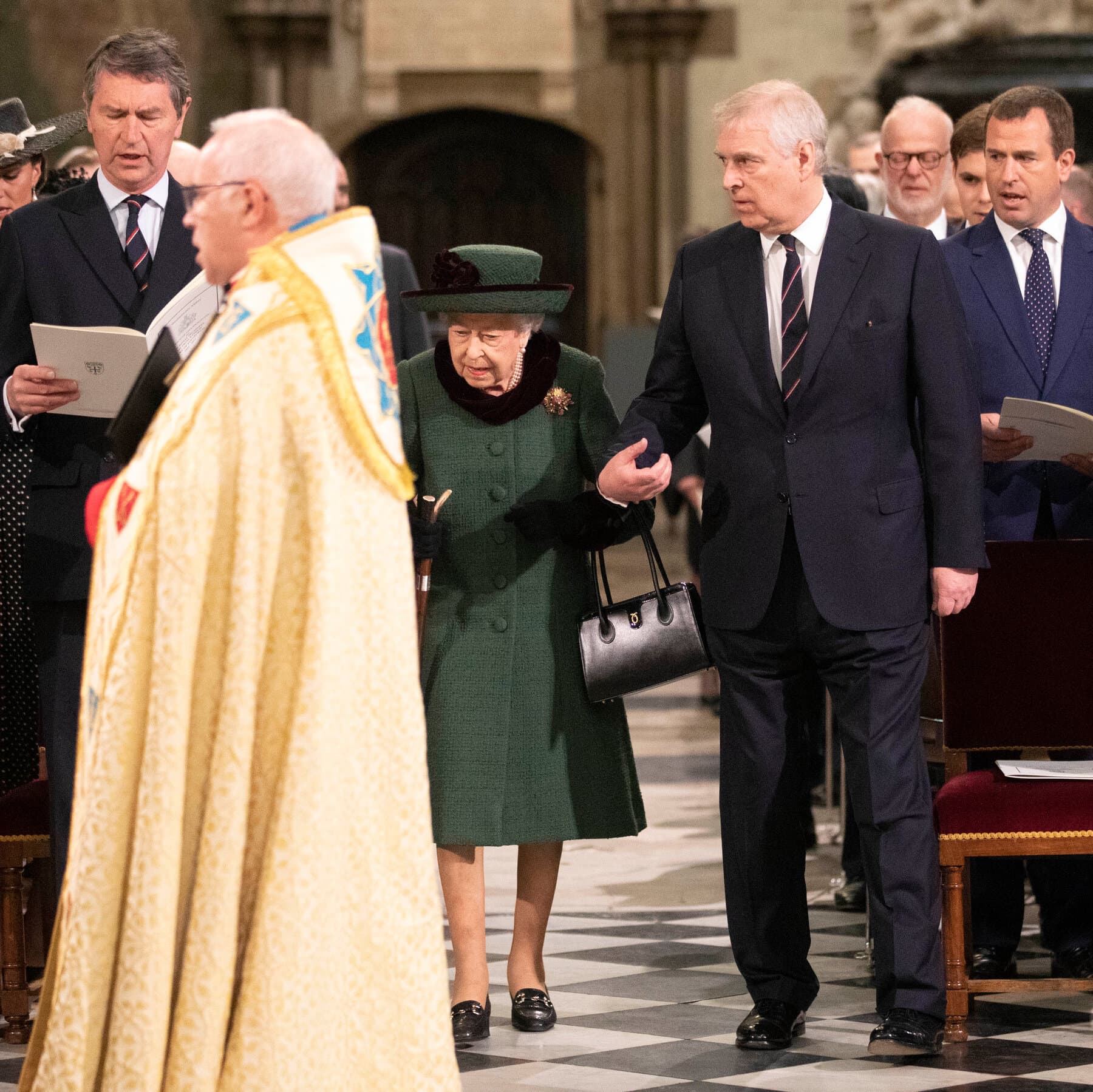 A moody, high-contrast illustration of a solitary, aging man in a suit looking out a grand palace window at a cold, gray English garden. In the background, a silhouette of a King walks away into the shadows, turning his back. The style should be cinematic and slightly desaturated.
