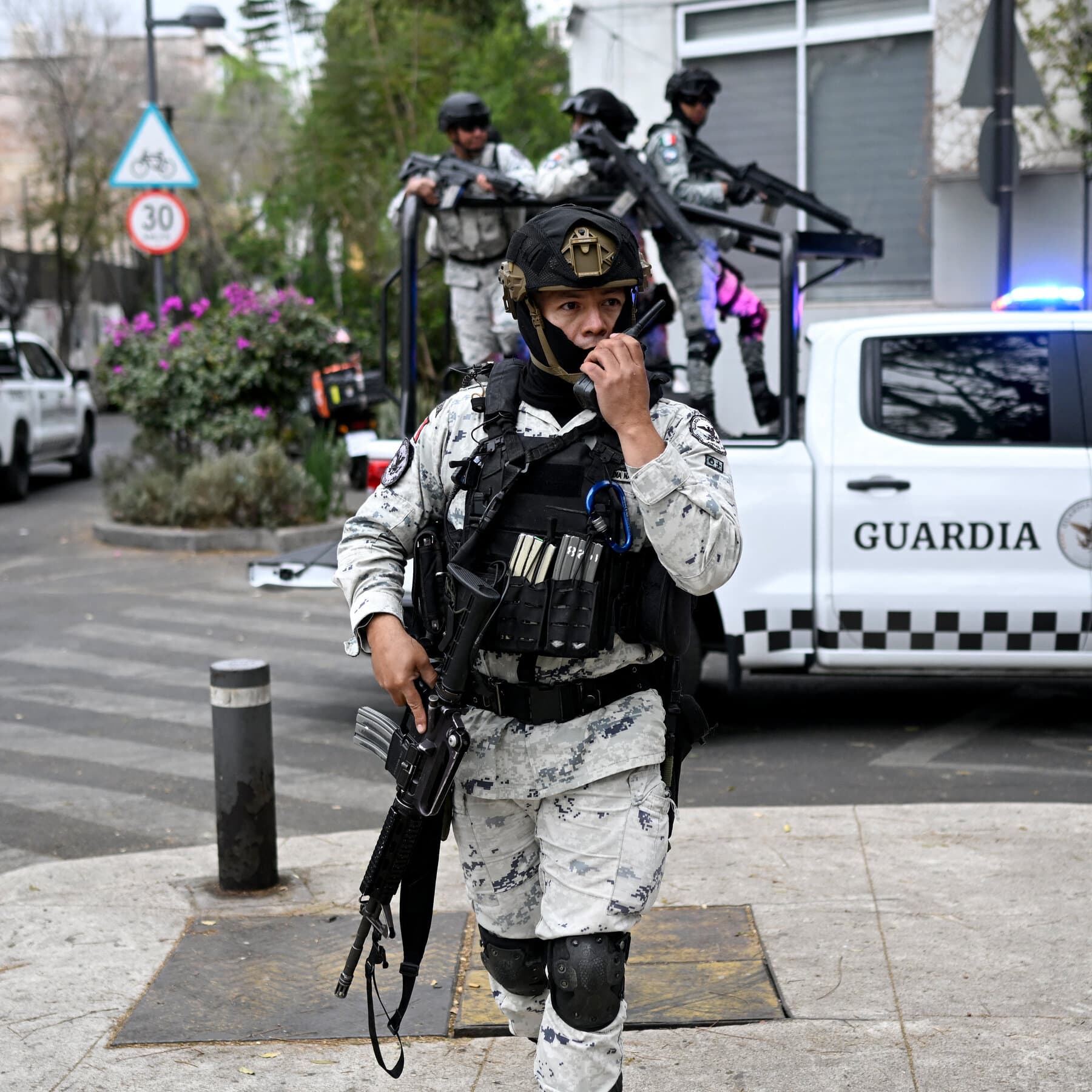 A surveillance camera mounted on a dirty wall focused on a bouquet of red roses lying on concrete, noir style, high contrast, dark atmosphere.