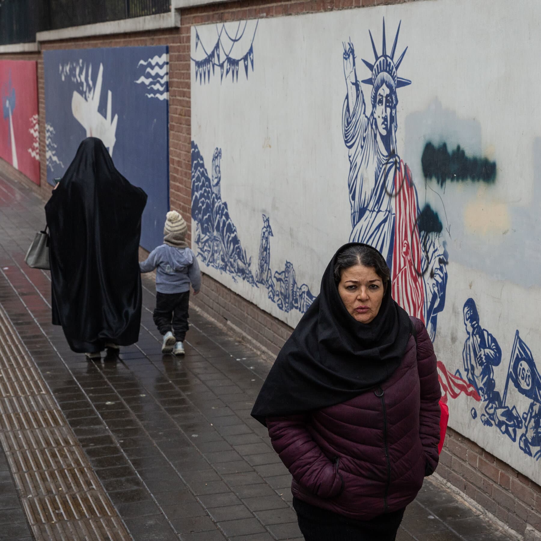 A hyper-realistic, slightly surreal image of a grocery store aisle in Iran. The shelves are perfectly, obsessively stocked with colorful boxes and bright fruit, glowing under harsh fluorescent lights. In the aisle, a shadowy, solitary figure stands looking at a carton of milk, but the shadow cast by the figure is shaped like a falling bomb. The atmosphere is quiet, sterile, and deeply ominous. Cinematic lighting, high contrast.