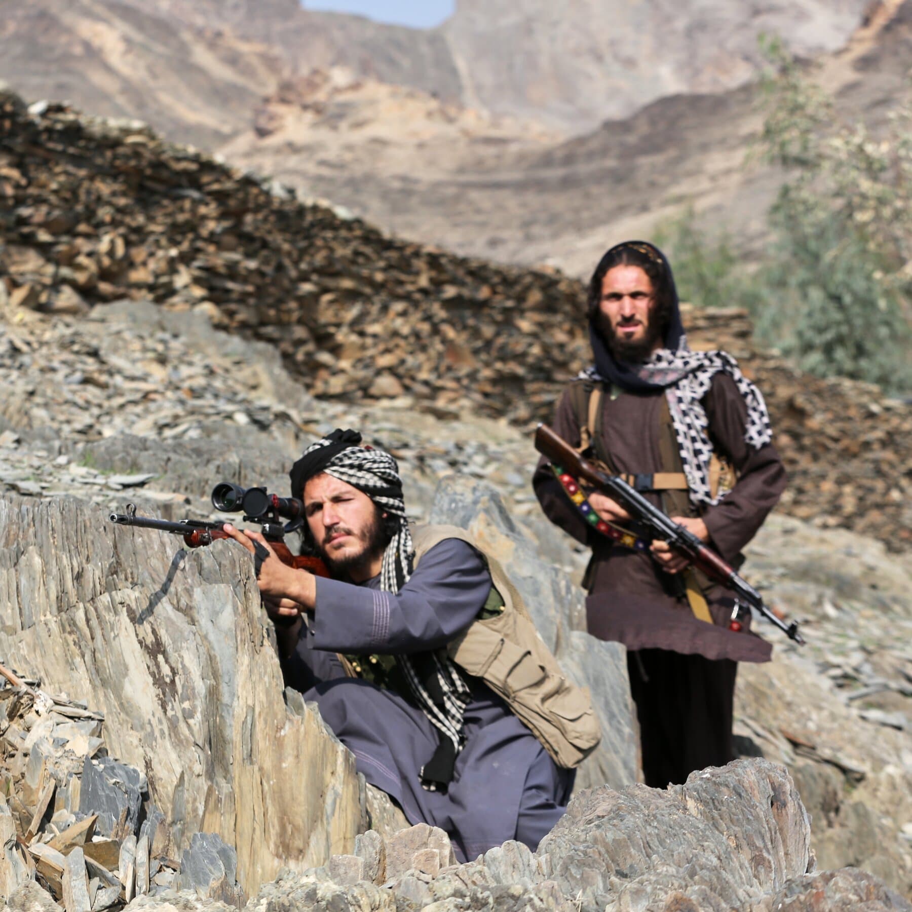 A split-screen composition emphasizing irony and conflict. On the left side, a stylized, gritty depiction of a dusty Afghan border crossing with smoke rising and barbed wire. On the right side, a view from inside a sleek, sterile government office in Islamabad where a military map is spread on a table, but the map is burning at the edges. The color palette should be muted earth tones contrasted with cold blues for the office.