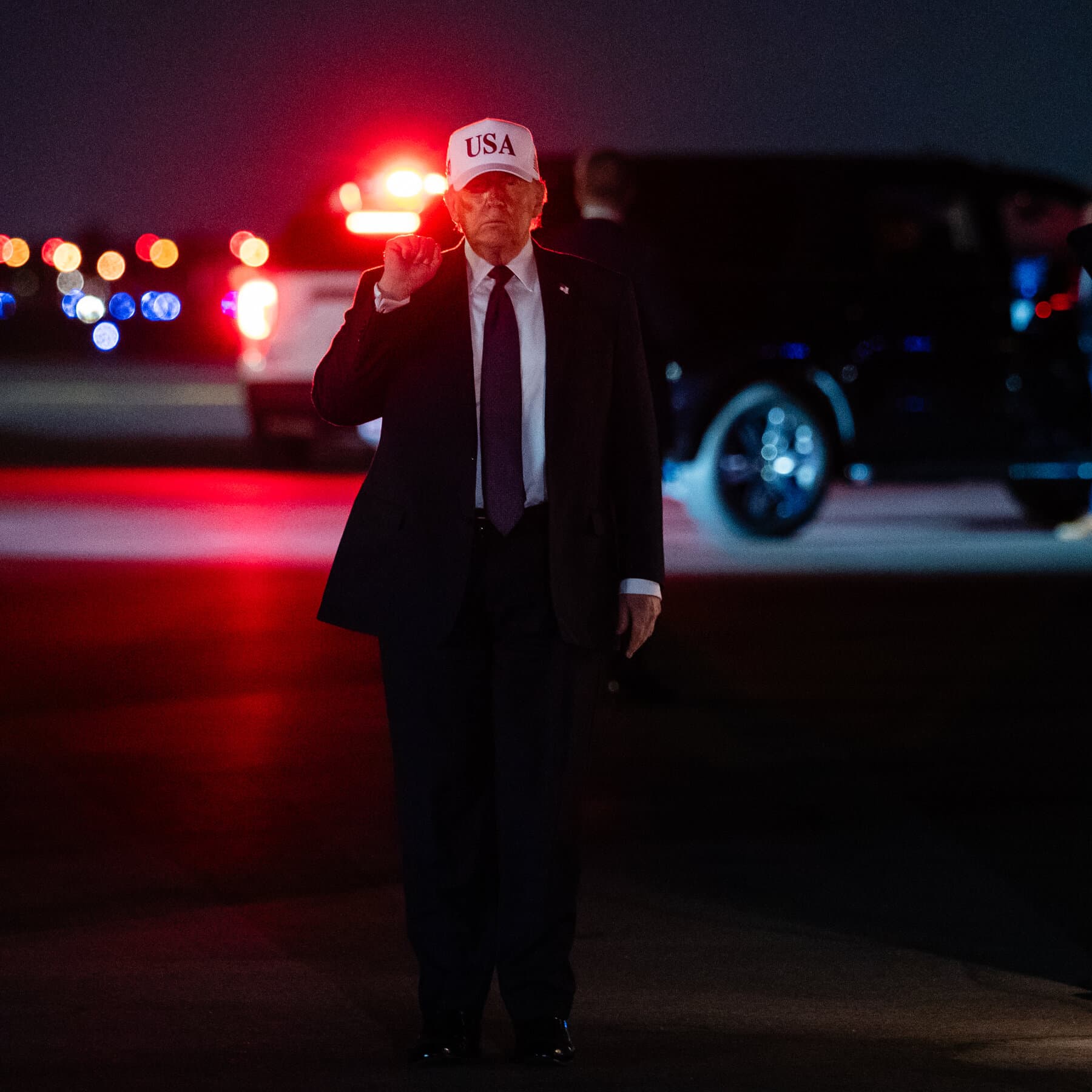 A dusty, antique scale of justice sitting on a heavy wooden desk. One side of the scale is weighed down completely by a modern, metallic missile. The other side holds a single, fragile rolled-up piece of parchment paper labeled 'Law', which is flinging upward into the air due to the weight imbalance. The lighting is dim and moody.
