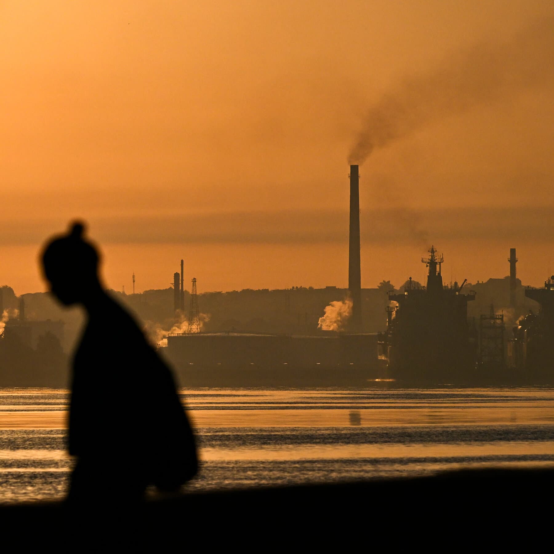 A gritty, cynical illustration showing a large oil barrel with a glowing green neon light on it, sitting on a broken dock. On one side, a caricature of a suit-wearing politician is holding a stop sign, and on the other side, a military-dressed figure is trying to grab the barrel. In the background, a dark city skyline with no lights. The style should be dark comic book noir.