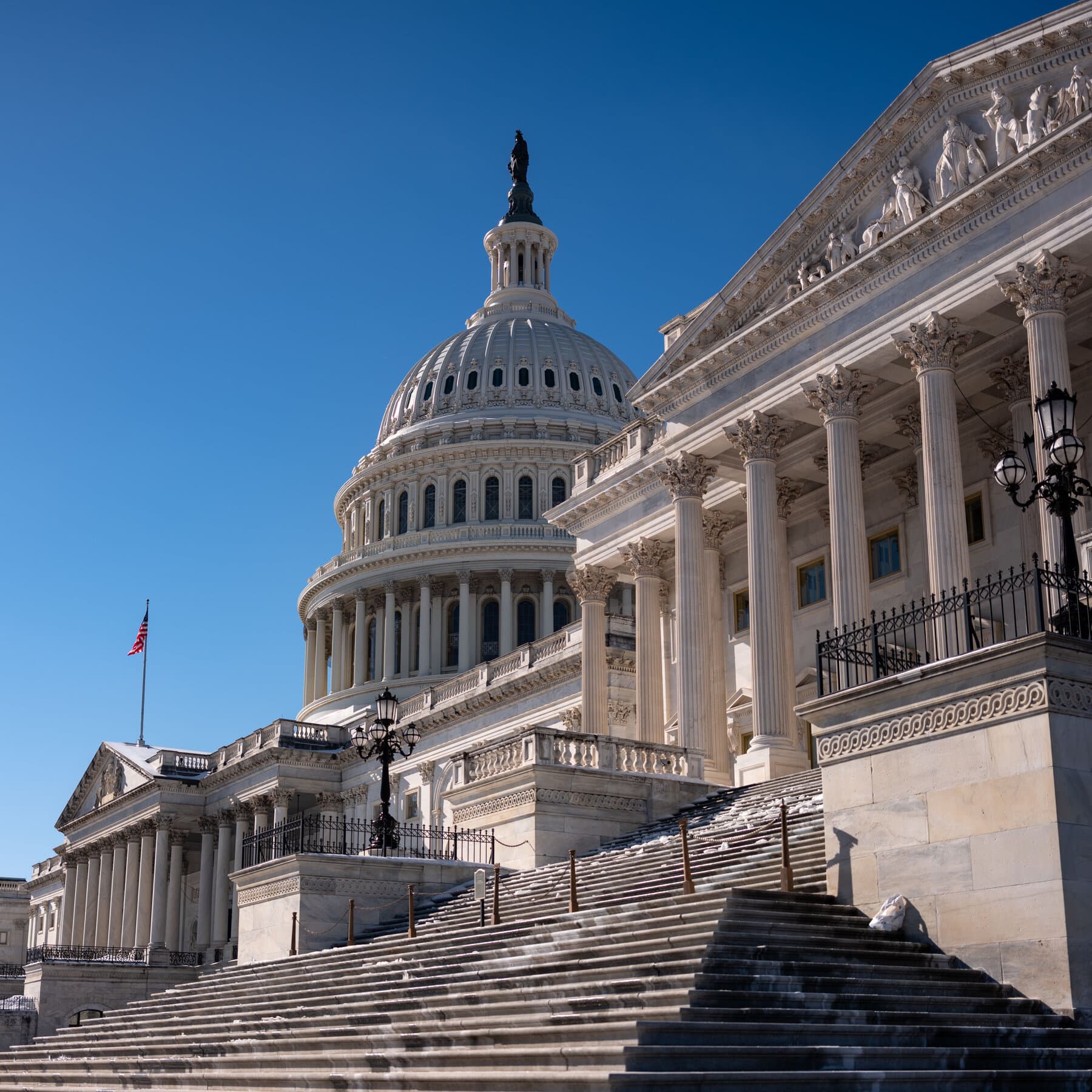 A cynical, noir-style illustration of a group of politicians in suits arguing angrily over a large clock that has no hands. The scene is dimly lit with high contrast shadows. The politicians look frustrated and confused. In the background, a large, looming shadow of a gavel hangs over them.